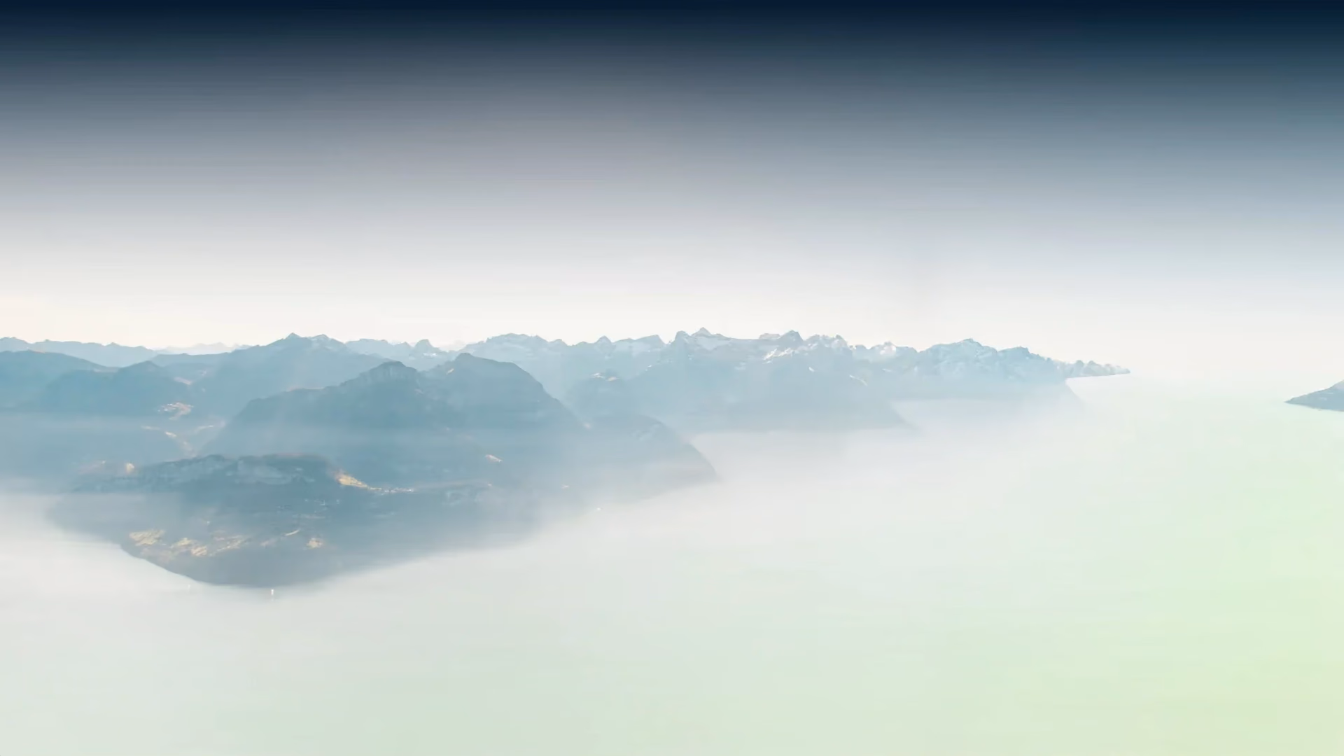 Mountain landscape with hiker standing on peak